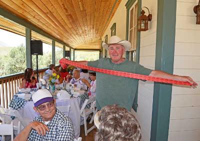 Lake County Supervisor Rob Brown selling a "stretch" of raffle tickets during lunch at “Picnic on the Porch” on Saturday, June 22, 2013, in Kelseyville, Calif. Photo by Greg Blinn. 062213elypicnicbrown