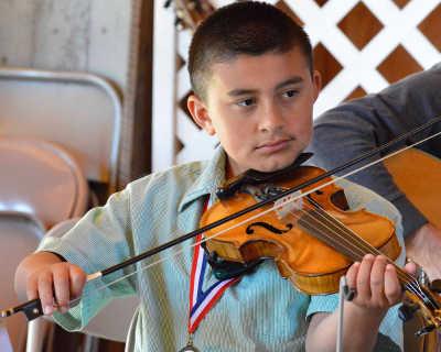 A youth fiddler performing as part of the Konocti Fiddle Club at the First Sunday Fiddlers Jam at the Ely Stage Stop in Kelseyville, Calif., on Sunday, April 6, 2014. Photo by Greg Blinn. 040614raphaelcontreras